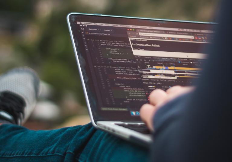 Man writing on laptop code